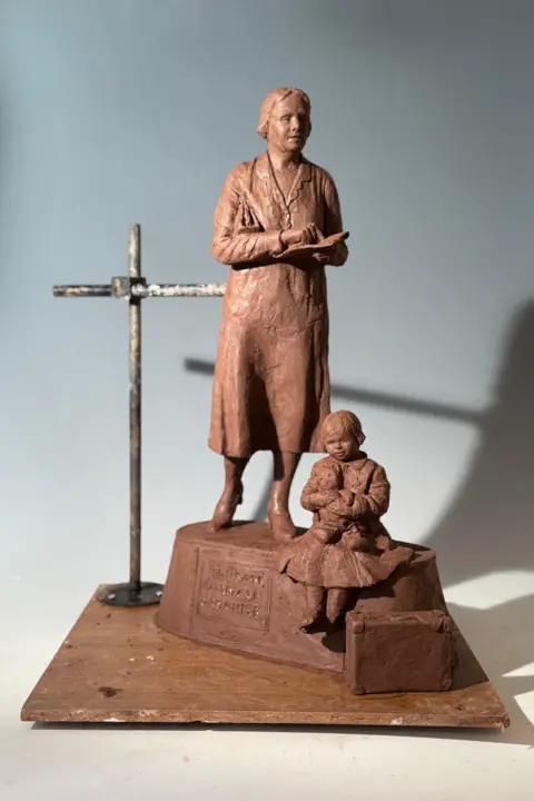 Billie Bond A mini version of the top statue of the woman and child.