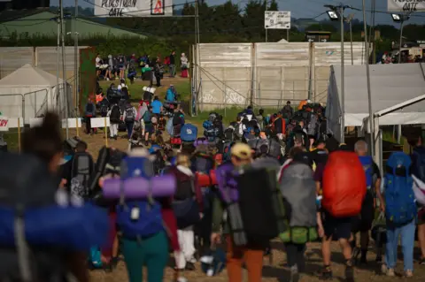 PA Media People seen leaving the Glastonbury Festival at Worthy Farm in Somerset.