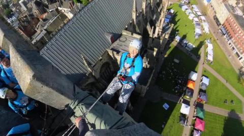 Anne Eyre abseiling down Exeter Cathedral