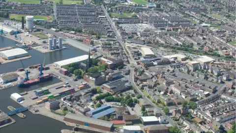 Aerial view of Goole showing the docks and houses on roads near the water 