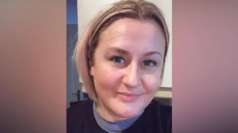 Leanne Canavan Headshot of Leanne Canavan who has blonde hair in a bob style. She is smiling and wearing a black jumper with a blue t-shirt underneath.