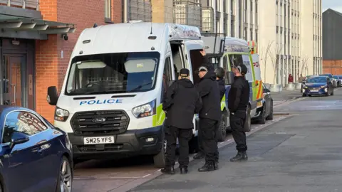 Leicester Media Online Police teams outside two parked police vans
