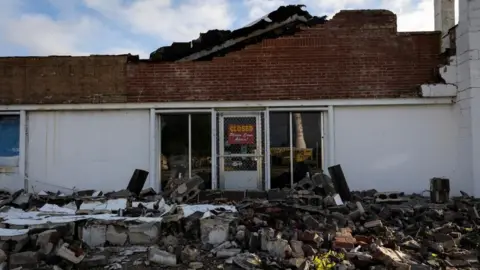 Debris in front of a damaged business in the aftermath of Hurricane Francine