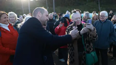 PA Media Prince of Wales taking a selfie with members of the public