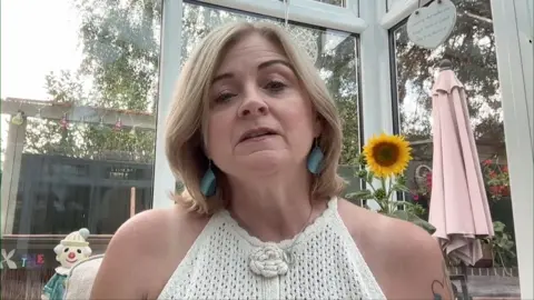 Debbie Adlam on a Zoom call from her conservatory