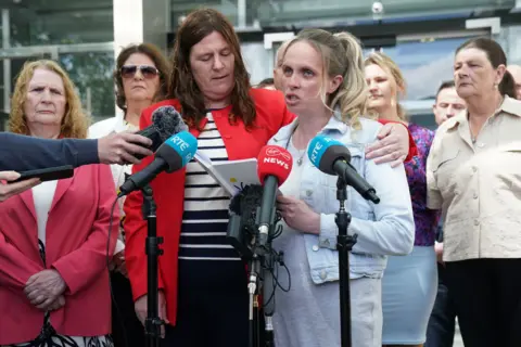 Brian Lawless/PA Wire Sarah Howard reading a statment into microphones outside the Central Criminal Court in Dublin. She is surrounded by other members of Tina Satchwell's family including her mother.