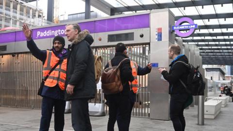 File image of station staff helping customers at Paddington station