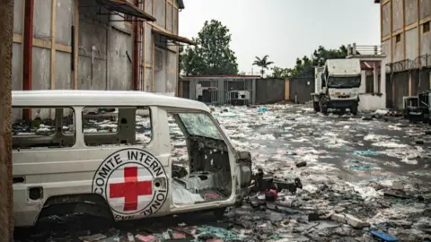 Destroyed International Committee of the Red Cross (ICRC) vehicles lie amid debris at a looted World Food Programme warehouse as M23 rebels retained control of the city on February 1, 2025 in Goma.