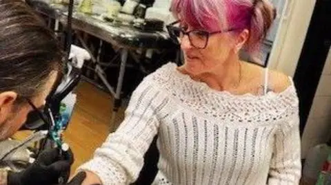 Leanda Kelly Leanda Kelly getting a semi colon tattoo.