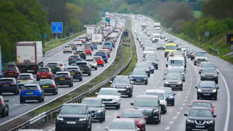 PA Media A picture of a busy dual carriageway with trees on either side.
