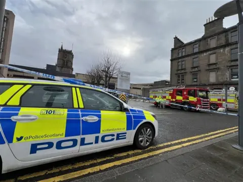 A police car and fire engine at the scene of an incident