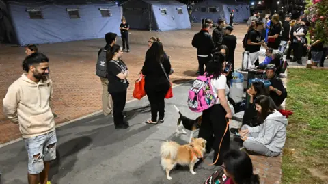 EPA Pozzuoli residents gather near makeshift tent camps after being made to evacuate their homes