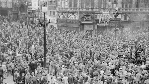 Picture looking down on a scene in Piccadilly Circus London, while they BBC broadcast their commentaries on VE Day May 8th 1945.