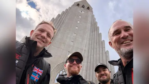 Handout A line-up of the four-man team with the top of the Hallgrímskirkja in the background.