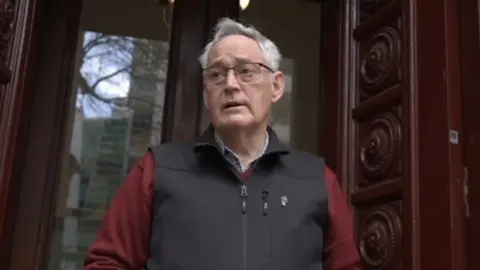 Ian Wilkinson standing outside court 