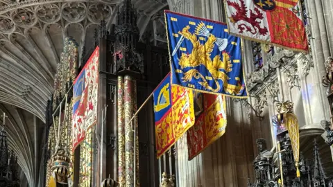 Banners hang near the roof of a chapel