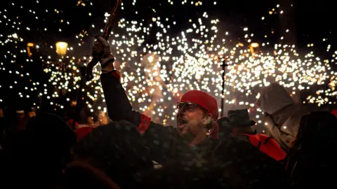 A crowd of people in front of bright lights