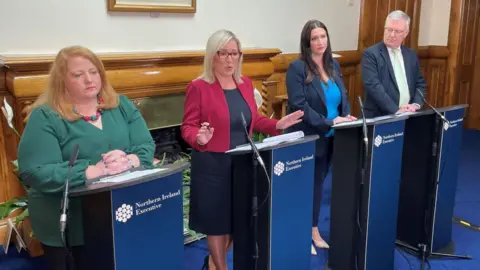 PA Justice Minister Naomi Long, First Minister Michelle O'Neill, deputy First Minister Emma Little Pengelly and Health Minister Mike Nesbitt during a Stormont Executive press conference at Stormont Castle, Belfast.