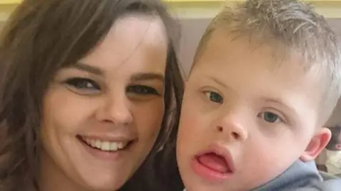 Tasha sat with her son TJ who has Down's syndrome