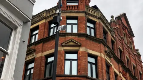 Image shows a speaker on a lamppost, which plays classical music to deter youths in Liverpool