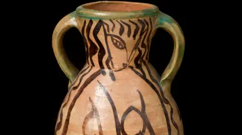 THE CHARLSETON TRUST A brown urn with two handles, glazed with a black abstract pattern, the work of Bloomsbury group artist Duncan Grant