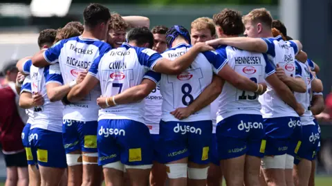 Bath players in a huddle during their match against Saracens
