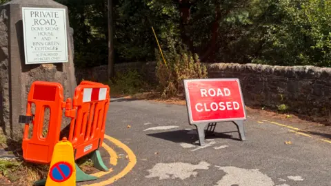 LDRS A road closure sign blocks off the entrance to a rural road