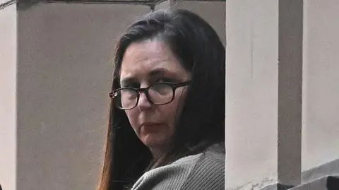 EPA Erin Patterson during trial in Melbourne wearing glasses and her dark her down.