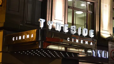 Ian Youngs/BBC The outside of the Tyneside Cinema which has a silver sign jutting out the side of the building. On top is 'Tyneside' written in white, bold font and 'Cinema' written on the side of the silver sign below.