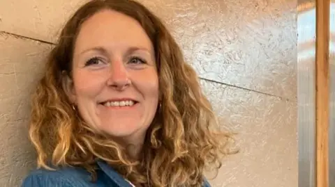The picture shows Claire before chemo, when she had shoulder length curly brown hair.
