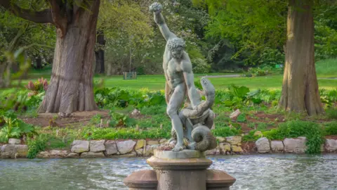 -JvL- The statue of Hercules fighting Achelous in Palm House Pond in Kew Gardens, London.