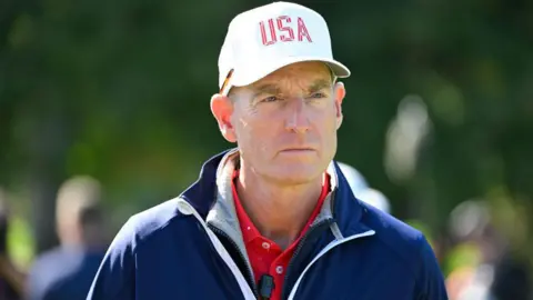 Jim Furyk wearing a white baseball cap with USA printed on the front