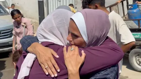 BBC Two Palestinian women hug as a medical evacuation prepares to leave Gaza (30/07/24)