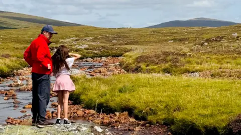 Anna Holligan's brother and her daughter in the Scottish Highlands