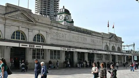 People walking in front of Cardiff Central rail station
