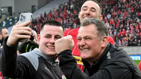 Reds boss Jim Magilton (right) celebrates after the Irish Cup triumph