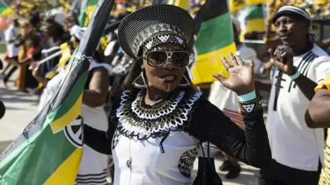 EPA performers hold the ANC flag during the final African National Congress (ANC) election rally held at FNB Stadium in Soweto, Johannesburg, South Africa, May 25, 2024