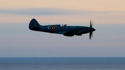 A Spitfire being flown over the sea