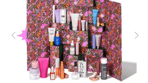 Space NK Space NK advent calendar showing a pink print box and various miniature beauty products