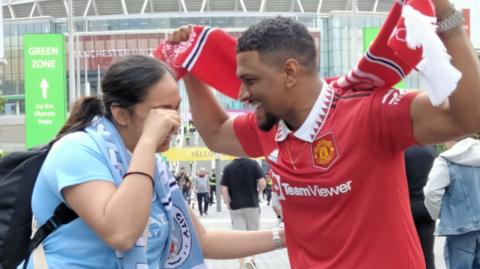 Manchester United fan Ludovic Brochard with his wife Valerie, a Manchester City fan, at the 2024 FA Cup final