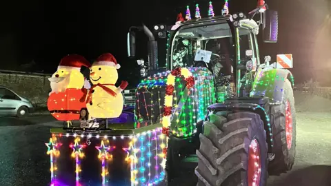 We are Farming Minds A tractor at last week's Herefordshire run is decorated with strings of lights and a glowing snowman and Father Christmas on the front.