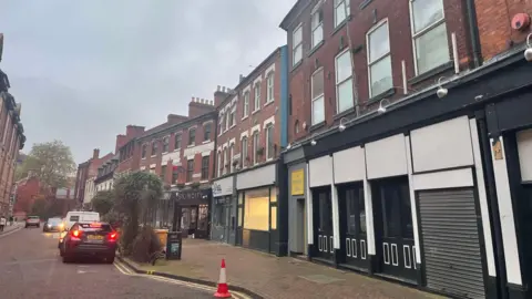 A view down the street with the Lily's Live Lounge site in the foreground