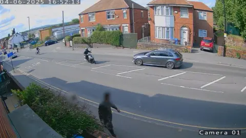 AA car driving on the wrong side of the road, with three bikers heading towards it