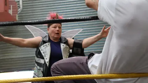 The character Titania attempting to hug Nick Bottom, after being fed a love potion which leaves her in love with the latter.
