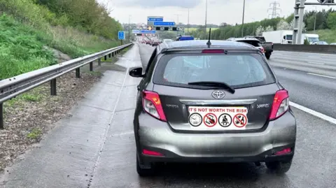 Hertfordshire Police A grey Yaris car stopped on the M1 motorway