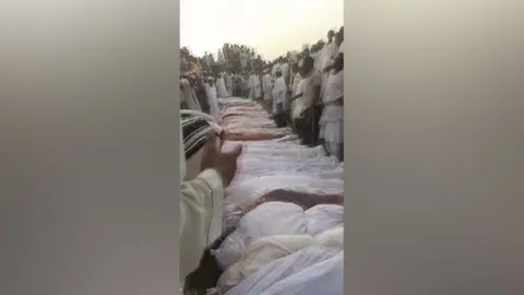 Shrouded bodies ready for burial in central Sudan - from footage uploaded to social media