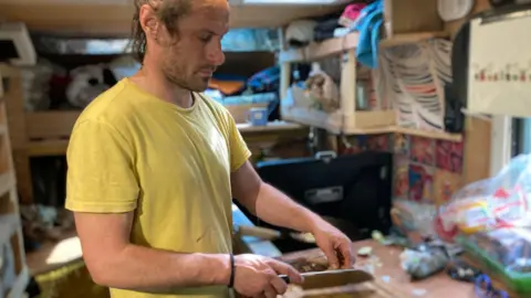 BBC Man making dinner in his van