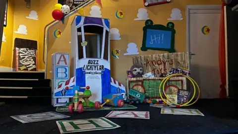 Hannah Cramp A collection of 'Toy Story' themed props stand in the foyer of the Palace Cinema, Haverfordwest. A toy box with 'Andy's Toys' painted on the lid, referencing a toy box in the Pixar franchise, is full of new and pre-loved toys donated by children who have attended screenings of the new movie.