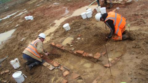 Workmen excavating at the site 