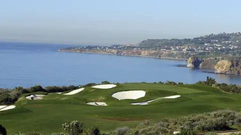 Getty Images A golf course with sand traps overlooks the ocean